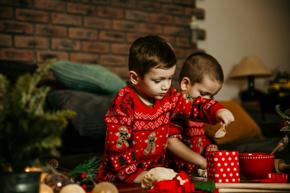 two young boys sitting on the floor playing with toys